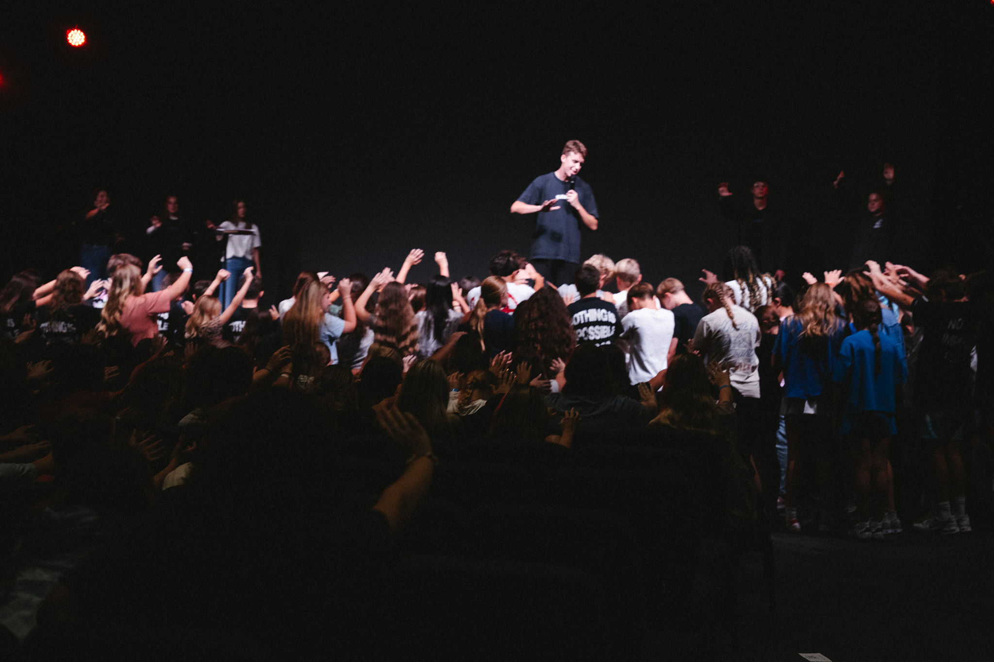 Students responding in prayer at an Elevate Wednesday night service